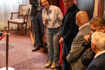 Uczestnicy wydarzenia stoją wokół wydzielonej części ekspozycji.