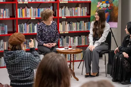 Rozmowa prowadzącej z młodą artystką podczas spotkania autorskiego w bibliotece.