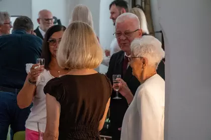 Uczestnicy jubileuszu rozmawiają podczas okolicznościowego poczęstunku.