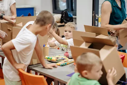 Dzieci tworzą własne kartonowe konstrukcje podczas zajęć.
