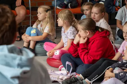 Uczestnicy z zainteresowaniem słuchają opowieści o zwierzętach.