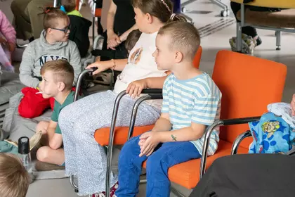 Dzieci z uwagą słuchają opowieści o mieszkańcach zoo.