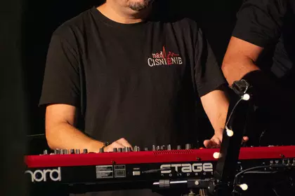 Muzyk zespołu Nadciśnienie gra na instrumencie klawiszowym.