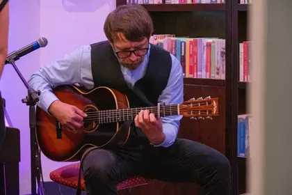 Gitarzysta akompaniujący podczas spotkania poetycko-muzycznego.