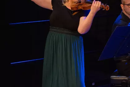 Ewelina Nowicka grająca na skrzypcach podczas koncertu.