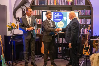 Dyrektor gratuluje laureatowi konkursu.